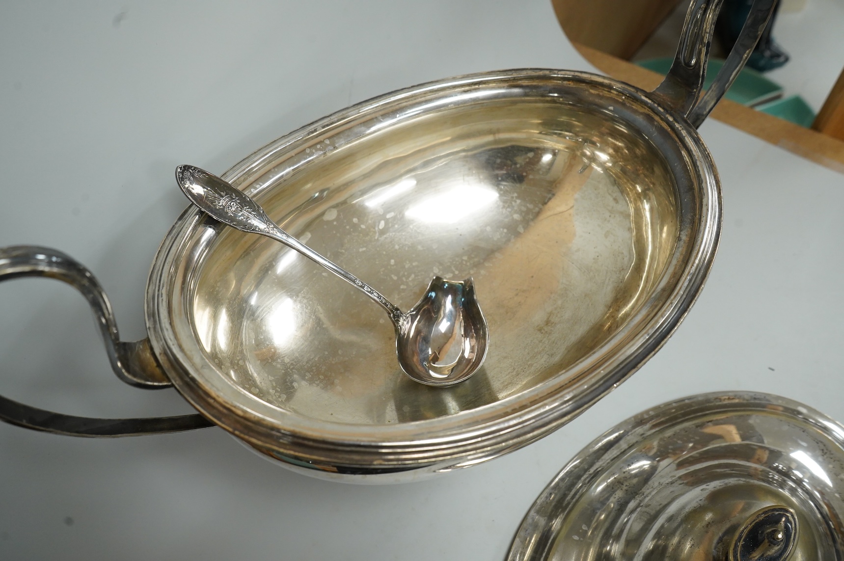 A late Victorian silver mounted claret jug (lacking cover), Holland, Son & Slater, London, 1882, height 21.1cm, together with a sterling sauce ladle, a plated two handled oval pedestal soup tureen and a cased set of six